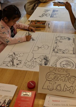 A little girl aged 4 or 5 draws one of the panels for the comic jam. The comic is about a young man who is on a first date with a robot.